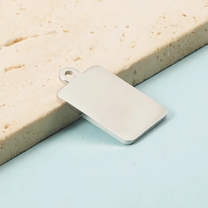 Macro detail of polished stainless steel rectangular pendant with small hole on stone