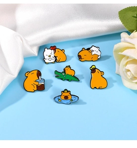 Detailed collection of six cute capybara enamel pins on elegant blue background