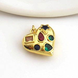 Macro shot of 18k gold heart pendant with colorful mixed-shape crystals for DIY jewelry