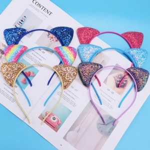Detail of six glitter cat ear headbands in candy colors set on a blue background