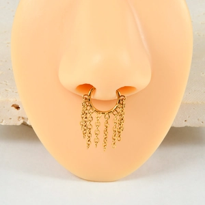 Detailed close-up of golden septum ring with fringe chains on a silicone model