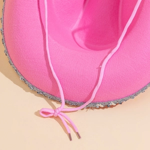 Detail of pink cowgirl hat featuring silver sequin trim and textured felt material