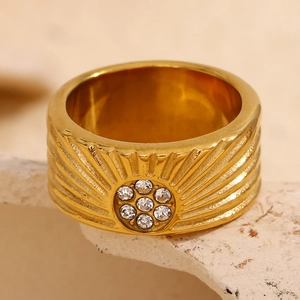 Detail of 18K gold plated wide ring with sunburst pattern and clear zircon stones