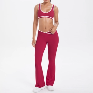 Detail of high-waist flared yoga pants and U-neck sports bra in dark red with white trim