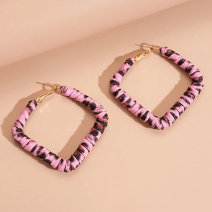 Detail view of pink leopard print square hoop earrings with luxury gold metal hardware