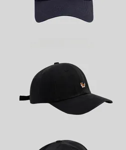 Detailed embroidery of a small Corgi dog on cotton baseball caps in black and navy colors