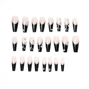 Long coffin black French press-on nails with white pearl accents and star patterns