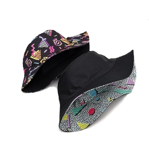 Reversible bucket hat with vintage colorful geometric pattern and plain black side