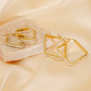 Gold plated square hoop earrings with micro-set crystals on elegant silk background