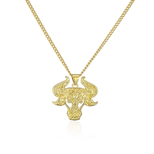 Macro shot of 18K gold plated bull head pendant necklace with vintage relief details