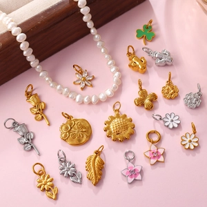 Exquisite gold and silver floral charms with enamel daisies and zircon on pink background