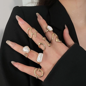 Detailed close-up of a vintage 7-piece gold alloy ring set with irregular pearls