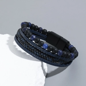 Detail of layered men's bracelet with matte beads, braided leather, and magnetic clasp