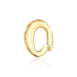 Macro shot of gold-plated Q-shaped pendant connector with polished mirror finish