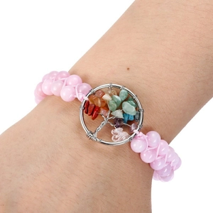Detail of pink beaded bracelet with a Tree of Life pendant featuring multi-color stones