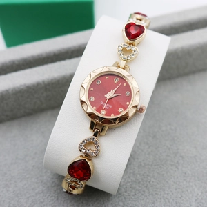 Luxury gold women's quartz bracelet watch with red heart gems and sparkling rhinestones