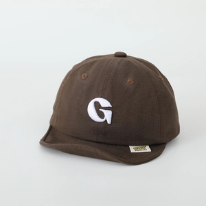 Detail of baby cotton cap with white 3D embroidered letter G and soft short brim