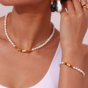 Detail of freshwater pearl necklace and bracelet set with golden square metal beads
