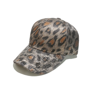 Detail view of stylish leopard print baseball cap with metallic gold foil finish