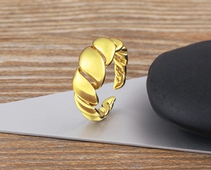 Detailed shot of a 18K gold plated brass ring featuring a unique twisted woven texture design
