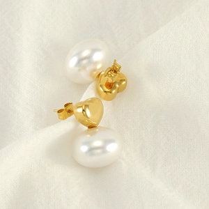 French vintage heart pearl earrings with gold plating on soft white texture
