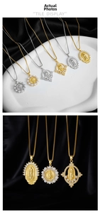 Macro detail of gold Virgin of Guadalupe pendants with rhinestones and pearl accents