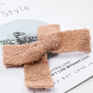Plush khaki felt bow Christmas tree pendant and hair clip on elegant magazine backdrop