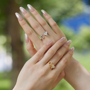 Detailed close-up of S925 sterling silver and gold adjustable rings with heart and C shape