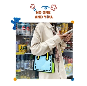 Detail of 2D cartoon style canvas tote bag with contrast colors and adjustable strap