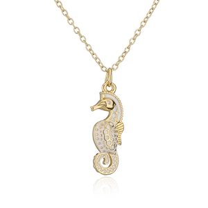 Close-up of a 18K gold seahorse pendant necklace with white enamel and a tiny zircon eye