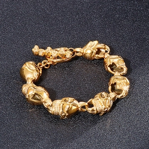 Close-up of golden punk skull bracelet with interlinked links and vintage OT toggle clasp