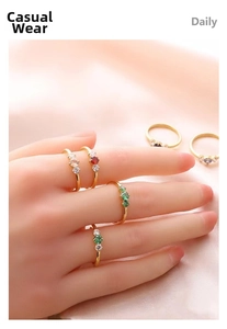Detailed macro view of gold-plated minimalist rings featuring vibrant triple stone settings