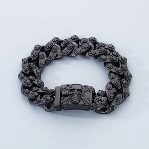 Detailed view of black titanium steel skull bracelet links with dark punk rock aesthetic