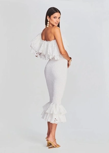 Détails de la robe en dentelle blanche avec volants et texture smockée sur le côté