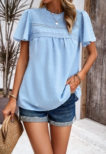 Detail of light blue Swiss dot top featuring delicate lace trim and ruffle sleeves