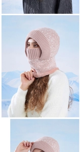 Close-up of pink knitted winter balaclava with warm faux fur lining against snowy mountains
