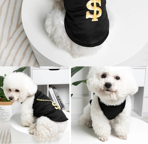 Detail shots of a black pet vest with a golden dollar sign print on a white dog
