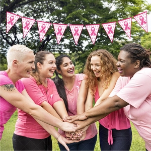Pink ribbon breast cancer awareness bunting banners displayed at a park charity event