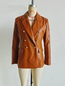 Detail of premium brown faux leather blazer with vintage golden embossed buttons