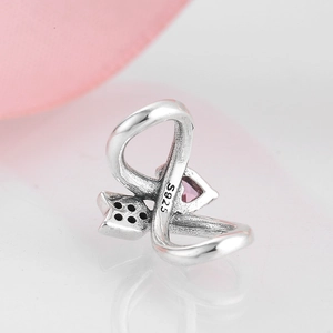 Macro shot of S925 sterling silver bead featuring pink heart gem and black pavé crystals