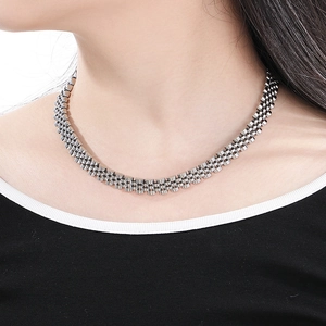 Close-up of 10mm silver stainless steel jubilee watch band style chain on a model's neck