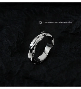 Detailed macro view of silver Mobius ring with 360-degree mirror polished surface