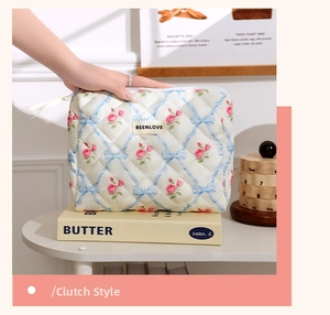 Detailed macro view of floral quilted makeup bag with pink roses and ribbon patterns