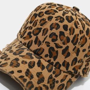 Detail of distressed leopard print baseball cap with vintage worn-out edge effects