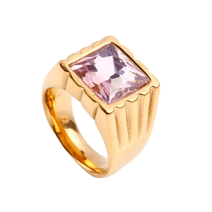 Macro shot of gold stainless steel ring with a large square pink gemstone and side grooves
