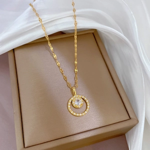 Luxe gold double circle necklace with micro-paved zircons on elegant silk background