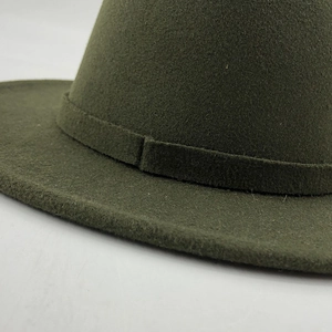 Detail of dark green wool felt hat showing the matching decorative band and thick texture