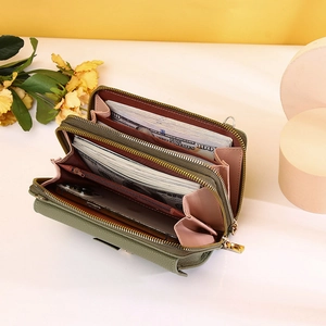 Detail view of large capacity olive green crossbody purse with dual zippers and phone slot