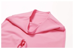 Macro shot of high waistband and flatlock stitching on pink flared yoga pants