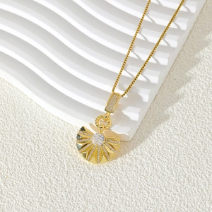 Gold-plated fan-shaped pendant necklace with sparkling cubic zirconia on a textured base